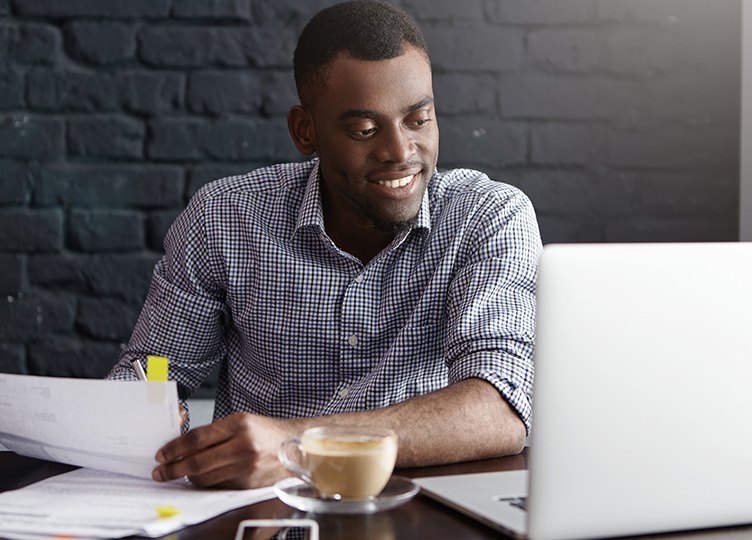 the happy man is working at the computer
