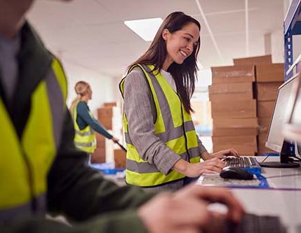 The staff in this busy warehouse is working on computer terminals.