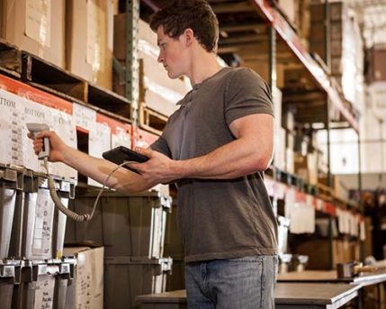 Stocking associate at work in a warehouse.